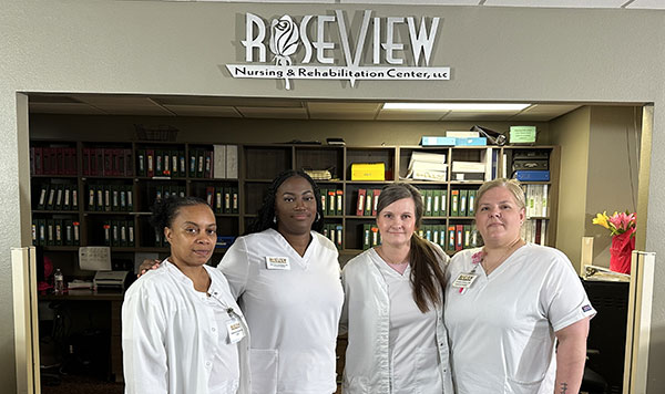 Group of therapists in front of Roseview sign.